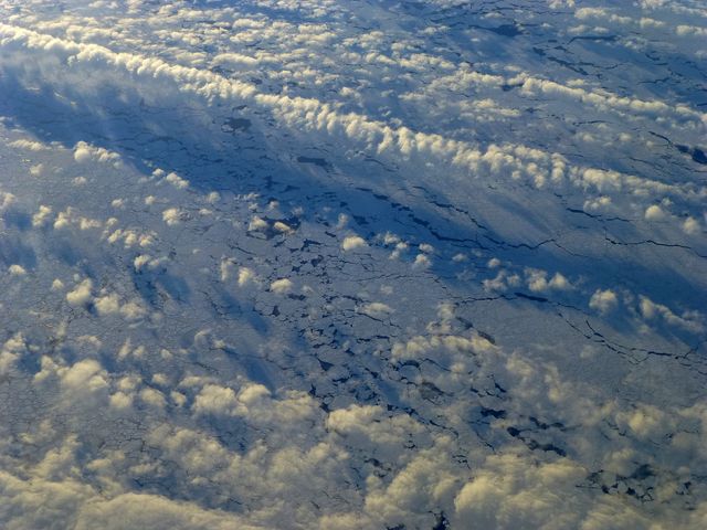 Image captures low-lying clouds hovering over the fragmented sea ice in the Bellingshausen Sea. This is part of NASA's Operation IceBridge, an airborne mission aimed at studying Earth's polar ice. Ideal for use in climate change research, educational materials, scientific publications, environmental documentaries, and awareness campaigns about polar regions and their importance.