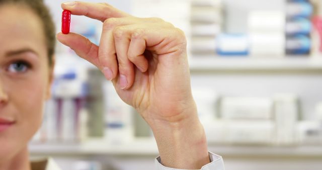 Pharmacist Holding Red Pill in Pharmacy - Download Free Stock Photos Pikwizard.com