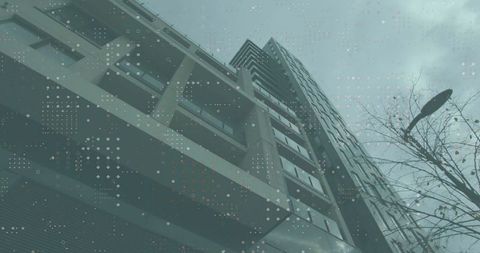 Modern Skyscraper Reaching Toward Cloudy Urban Skies