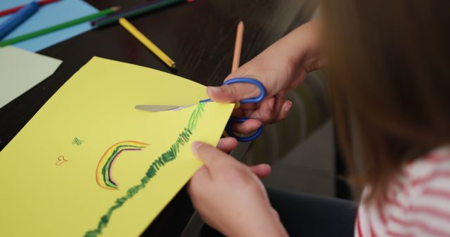 Child Creating Art, Drawing Rainbow on Yellow Paper, Using Scissors and Colored Pencils - Download Free Stock Images Pikwizard.com