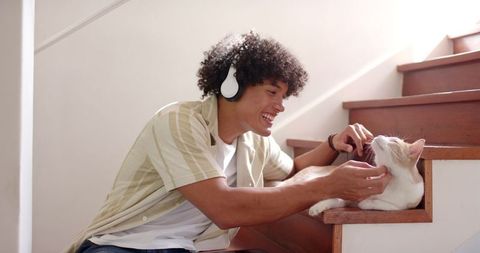 Man Enjoys Quality Time with White Cat on Stairs