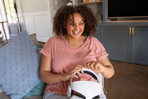 Woman enjoying vr technology in cozy home setting
