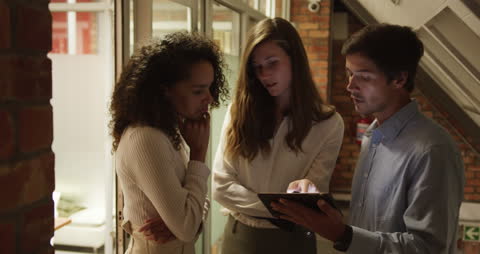 Diverse Professionals Collaborating on Tablet Project