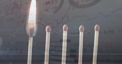 Burning matches symbolizing financial risk with revenue charts