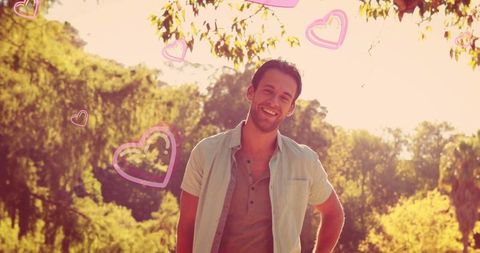 Happy Young Man Enjoying Nature with Romantic Pink Heart Overlays