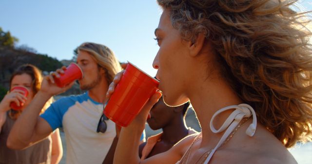 Group of Friends Drinking and Relaxing Outdoors at Sunset - Download Free Stock Images Pikwizard.com