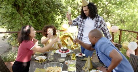 Cheerful Birthday Celebration with Friends on Outdoor Patio