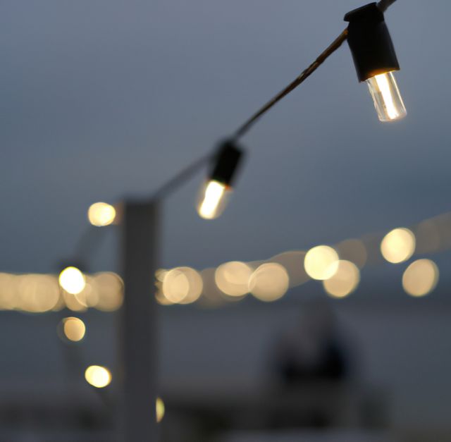 Image of close up of outdoor lights on string on beach at night - Download Free Stock Photos Pikwizard.com