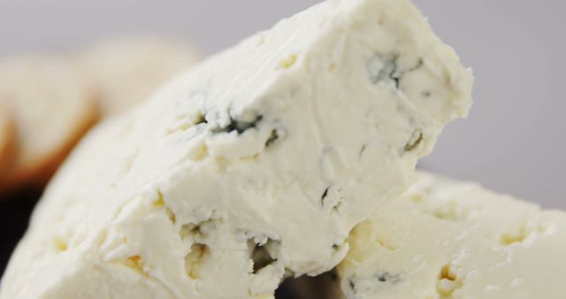 Creamy blue cheese displayed close-up revealing its texture. Perfect for use in culinary blogs, gourmet food websites, or promotional materials for cheese and dairy products.