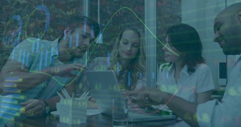 Collaborative team analyzing financial charts on laptop with data visualization overlay