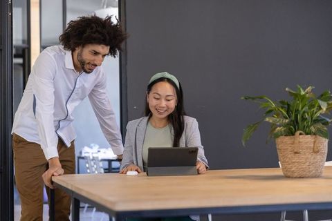 Diverse Coworkers Collaborating on Technology Project in Modern Office