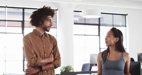Diverse Colleagues Engaging in Discussion at Modern Office