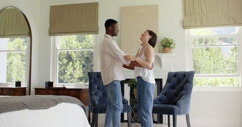 Affectionate couple enjoying intimate moment in cozy bedroom