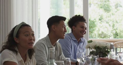 Friends Sharing Joyful Moments at Wedding Reception