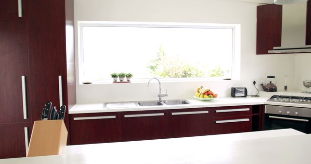 Modern Kitchen Interior with Red Wood Cabinets and White Countertops - Download Free Stock Photos Pikwizard.com