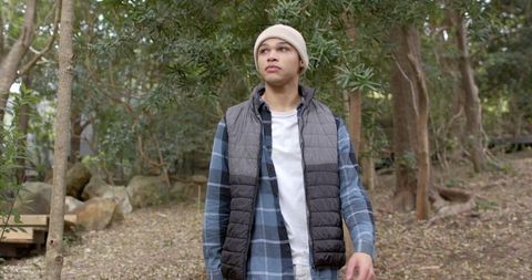Young Man Exploring Forest in Casual Winter Clothing