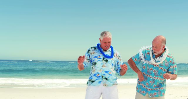 Two senior men dance joyfully on the beach wearing Hawaiian shirts and leis. The ocean and clear sky create a relaxing and fun atmosphere. Ideal for content related to active retirees, summer vacations, tropical destinations, and senior lifestyle.