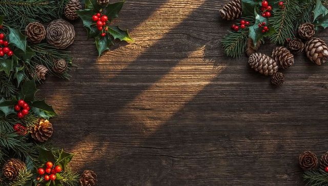 Rustic Holiday Flatlay Framing Wooden Tabletop with Pinecones, Holly and Sunlit Shadows