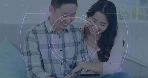 Smiling Couple Using Tablet with Futuristic Overlay