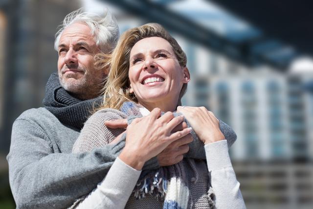 Digital composite of Senior man embracing woman in city