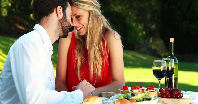 A young Caucasian couple enjoys a romantic outdoor picnic, with copy space - Download Free Stock Photos Pikwizard.com