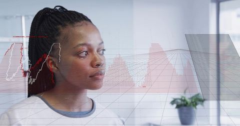 Young professional studying interactive data visualization overlay in bright office