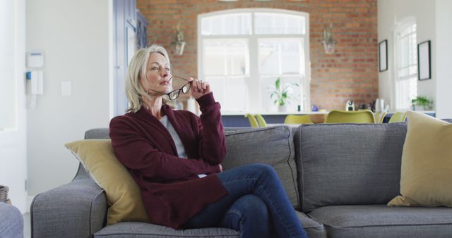 Pensive Mature Woman Sitting on Sofa - Download Free Stock Images Pikwizard.com