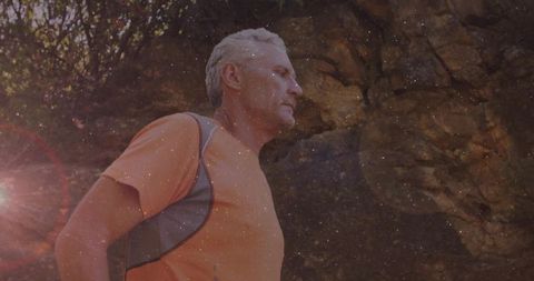 Mature Man Hiking on Rugged Canyon Trail During Sunset Adventure