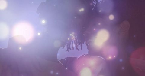 Silhouetted couple with glowing bokeh and vibrant intimacy