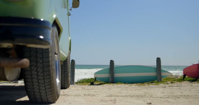 Van and surfboard on the beach. Bright sunny day 4k