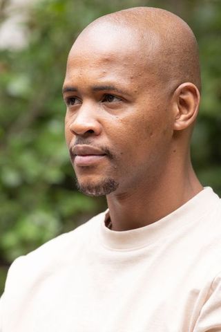 Contemplative african american man looking left outdoor closeup portrait soft bokeh
