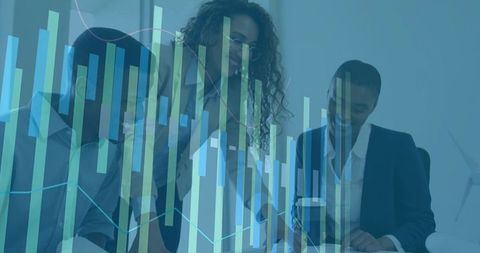 Business Team Analyzing Financial Data with Graphs in Modern Office