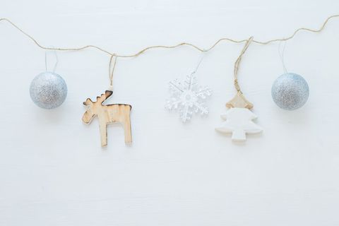 Minimal christmas garland with decorations against white background
