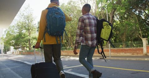 Friends Walking with Backpacks on City Street in Daylight - Download Free Stock Images Pikwizard.com