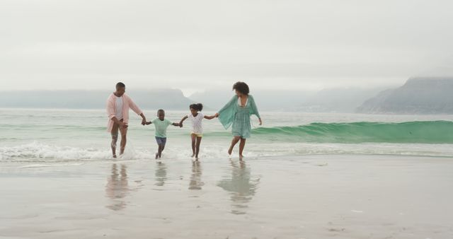 Family enjoying a day together at the beach. Ideal for vacation advertisements, family lifestyle promotions, and travel brochures. Emphasizes joy, unity, and relaxation.