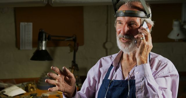 Senior Artisan Speaking on Smartphone in Workshop - Download Free Stock Images Pikwizard.com