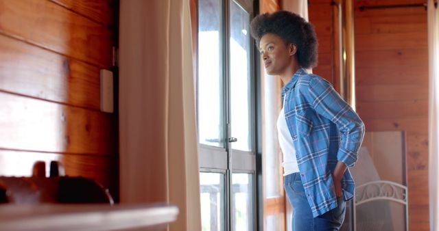 Thoughtful Woman Looking Through Window in Cozy Rustic Cabin - Download Free Stock Images Pikwizard.com