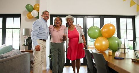 Happy Seniors Preparing Birthday Celebration with Decorations