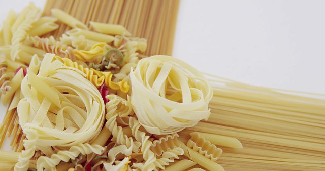 Assorted Uncooked Pasta Variety on Light Background - Download Free Stock Images Pikwizard.com