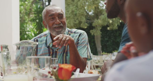 Senior Man Enjoying Outdoor Meal with Family, Sharing Stories - Download Free Stock Images Pikwizard.com