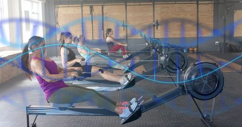 Women exercising on rowing machines with dna overlay