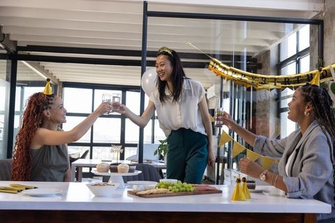 Diverse colleagues celebrating at elegant office party