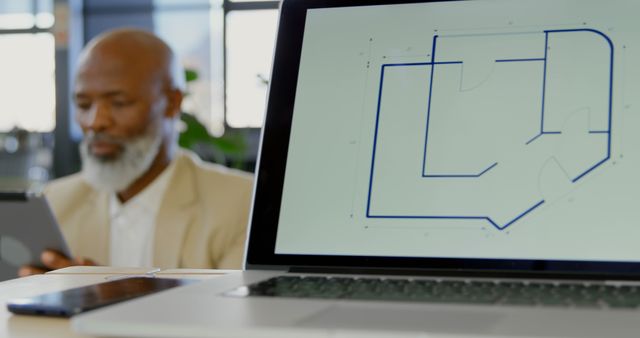 Architect working with digital floor plan on laptop in modern office - Download Free Stock Images Pikwizard.com