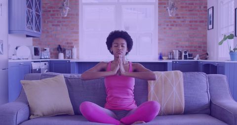 Young Woman Meditating in Cozy Living Room Setting