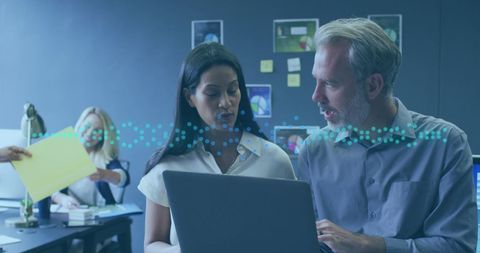 Coworkers Collaborating on Data Analysis in Modern Office