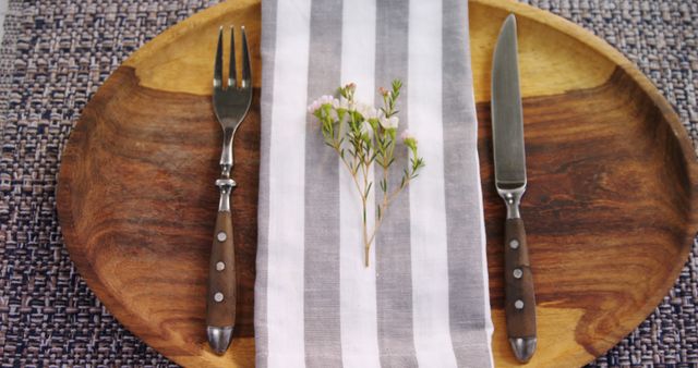 Elegant Table Setting with Wooden Plate, Striped Napkin and Flower - Download Free Stock Images Pikwizard.com