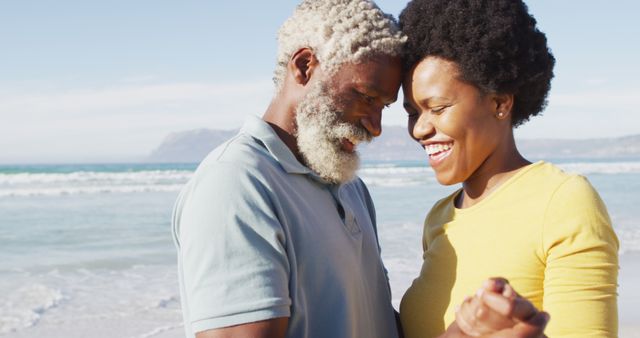 Happy african american couple dancing together on sunny beach. healthy and active time beach holiday.