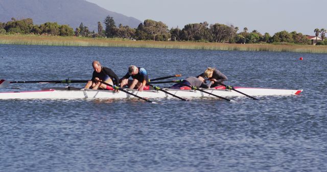 Four senior caucasian men and women in rowing boat resting. sport retirement leisure hobbies rowing healthy outdoor lifestyle.