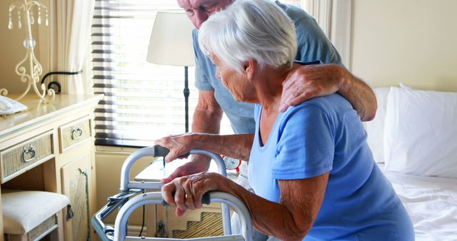 Senior man helping elderly woman with walker in bedroom - Download Free Stock Images Pikwizard.com