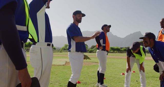 Baseball Team Training on Field with Coach in Sunshine - Download Free Stock Images Pikwizard.com